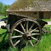 Old wooden cart in front of barn in the open air museum Bokrijk, Genk
